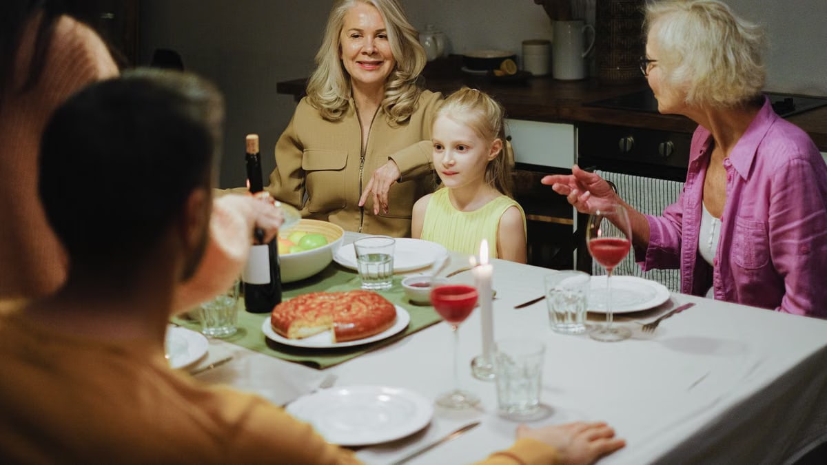 A multigenerational family enjoying dinner together at home, highlighting family bonds and togetherness.